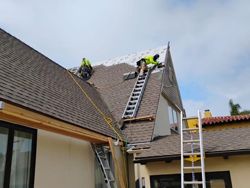 Roofer installing new shingles